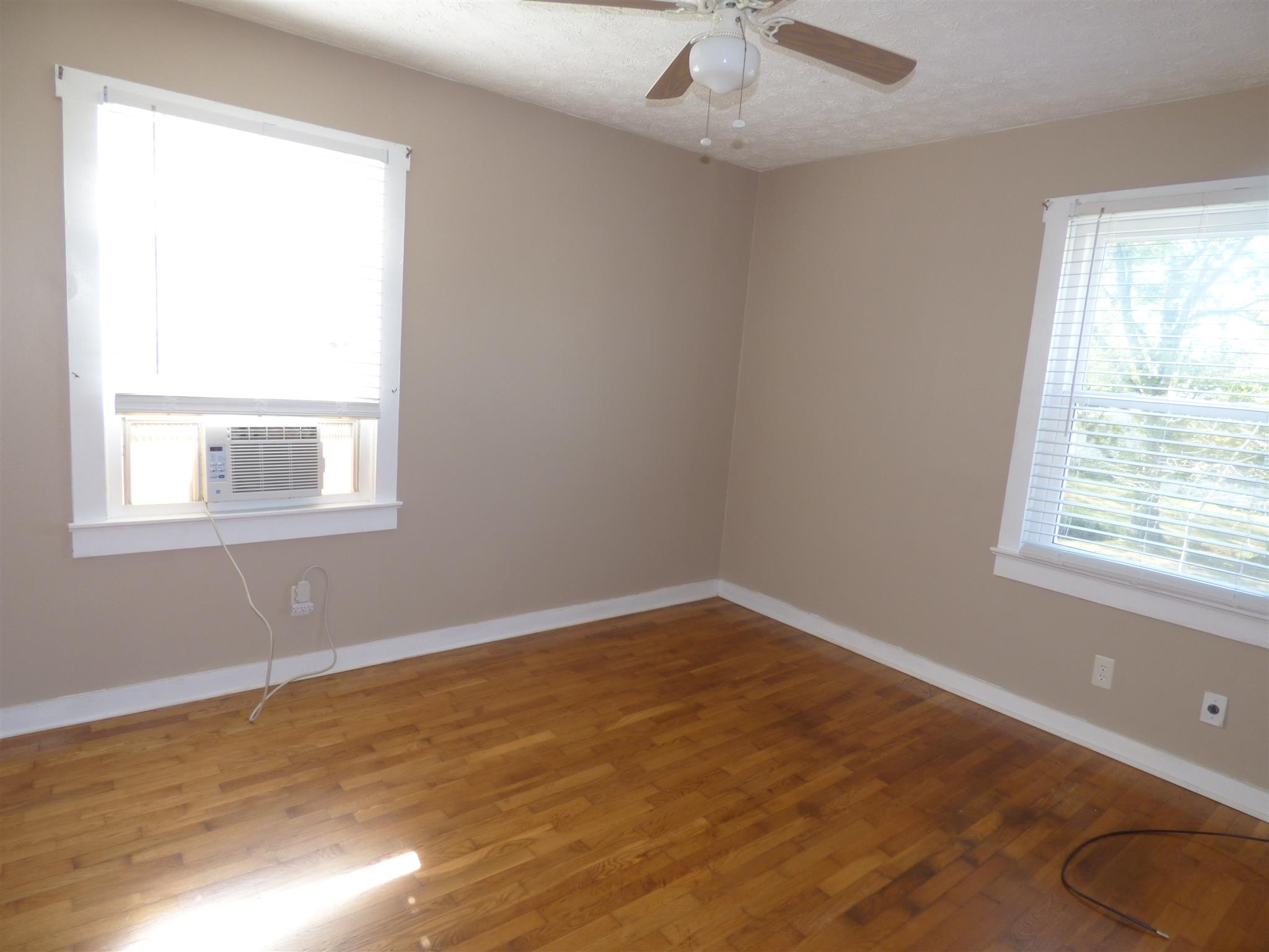1259 1st Avenue Mount Pleasant, TN 38474 - Photo 11 of 18 a view of an empty room with wooden floor and a window