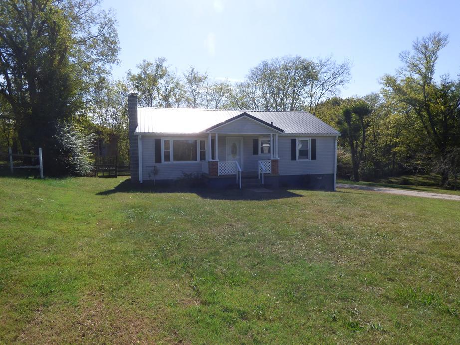1259 1st Avenue Mount Pleasant, TN 38474 - Photo 18 of 18 a view of a yard in front of a house with large trees