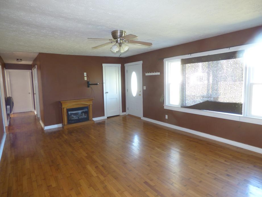 1259 1st Avenue Mount Pleasant, TN 38474 - Photo 3 of 18 a view of an empty room with a window and wooden floor