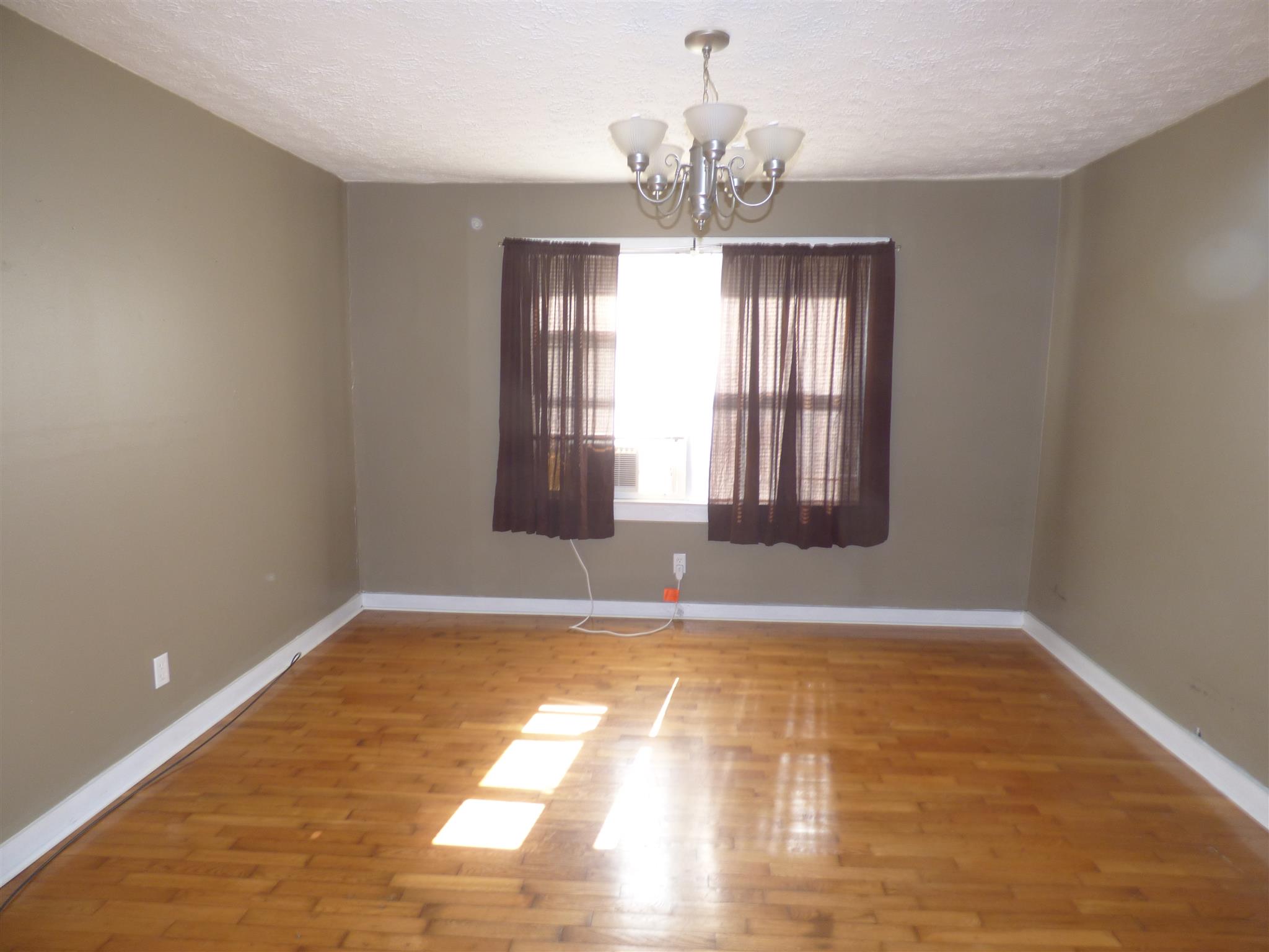 1259 1st Avenue Mount Pleasant, TN 38474 - Photo 5 of 18 a view of an empty room with wooden floor and a window