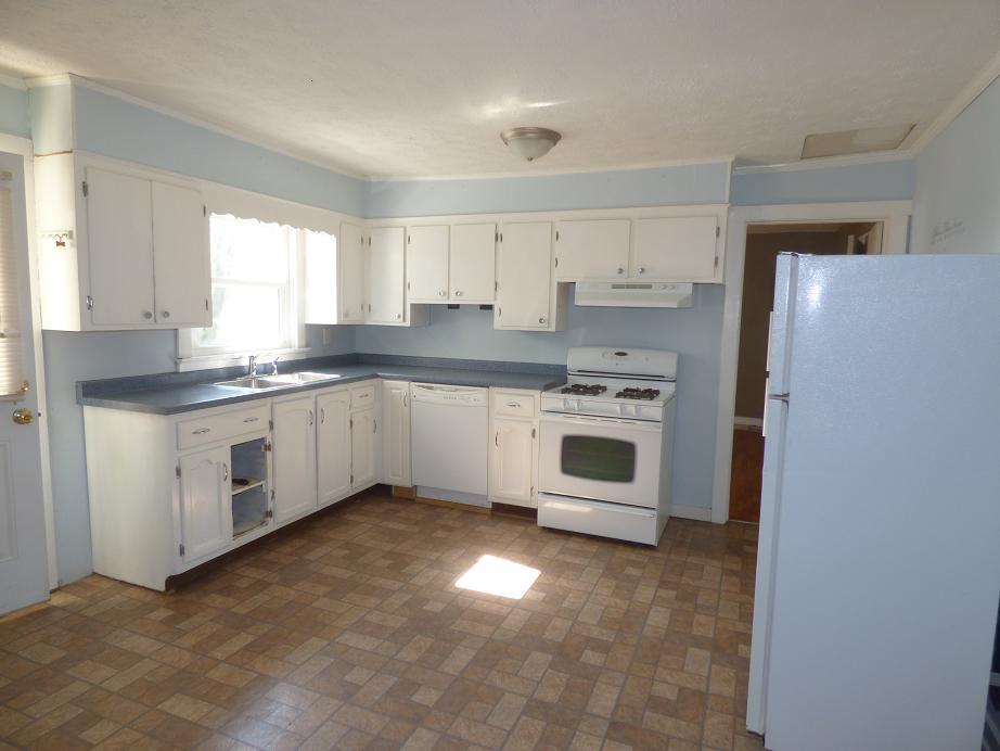 1259 1st Avenue Mount Pleasant, TN 38474 - Photo 7 of 18 a kitchen with stainless steel appliances granite countertop a stove a sink and a refrigerator