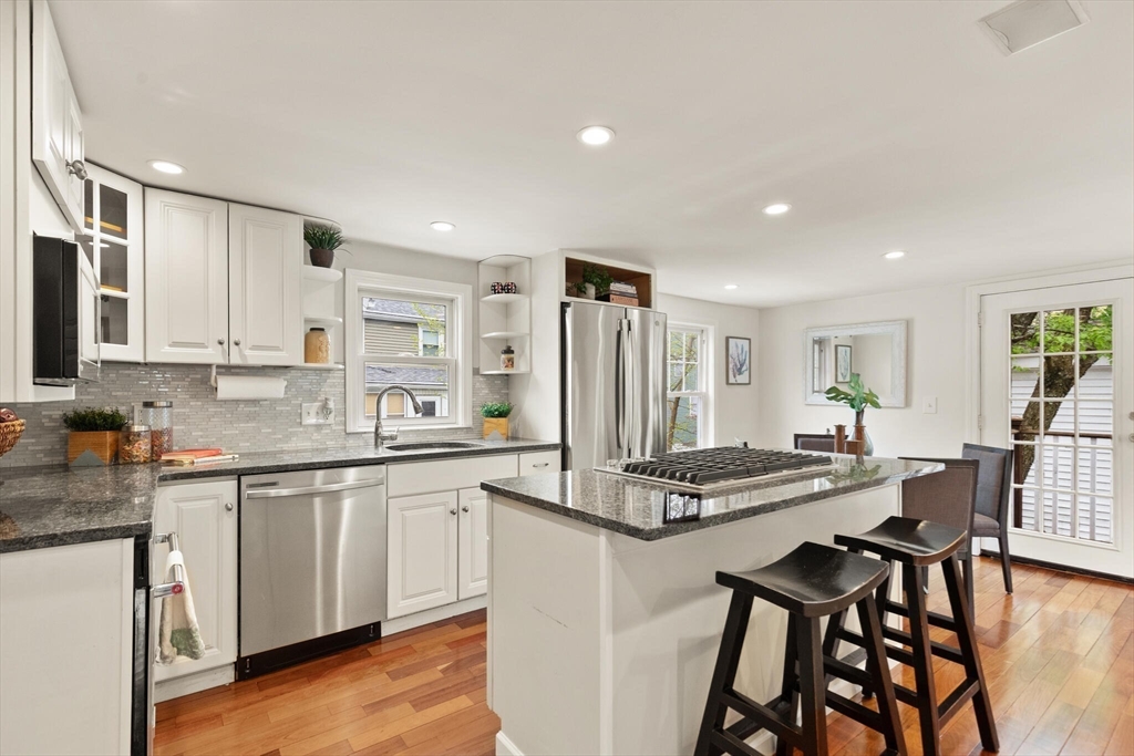 151 Forest Street Malden, MA 02148 - Photo 11 of 33 a kitchen with stainless steel appliances granite countertop a stove a sink dishwasher and a refrigerator