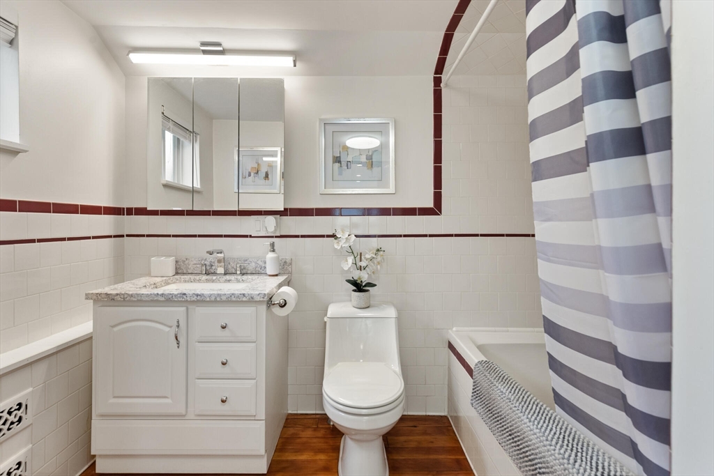 151 Forest Street Malden, MA 02148 - Photo 22 of 33 a bathroom with a granite countertop toilet sink and mirror