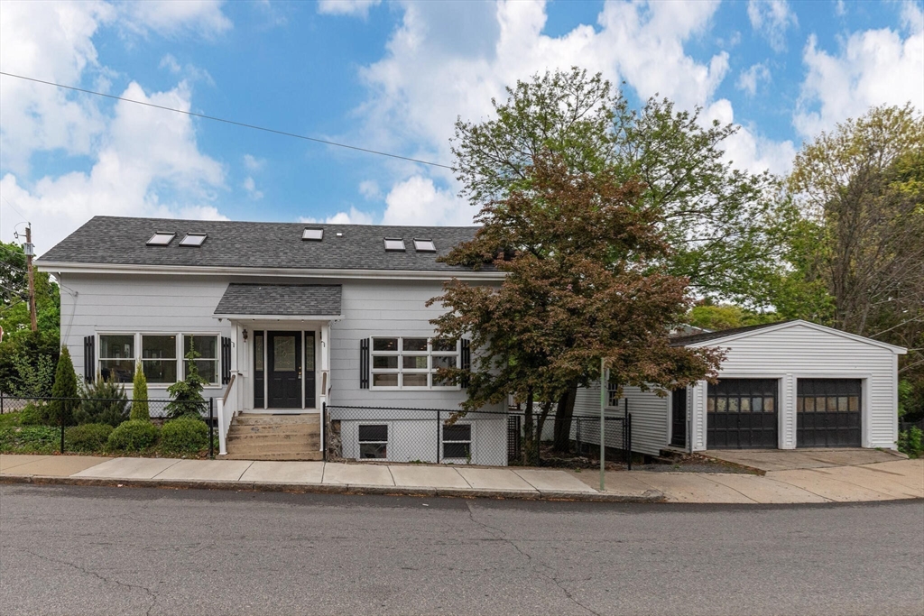 151 Forest Street Malden, MA 02148 - Photo 26 of 33 a front view of a house with a garden and trees