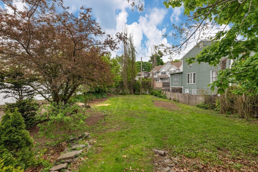 151 Forest Street Malden, MA 02148 - Photo 29 of 33 a backyard of a house with plants and large trees
