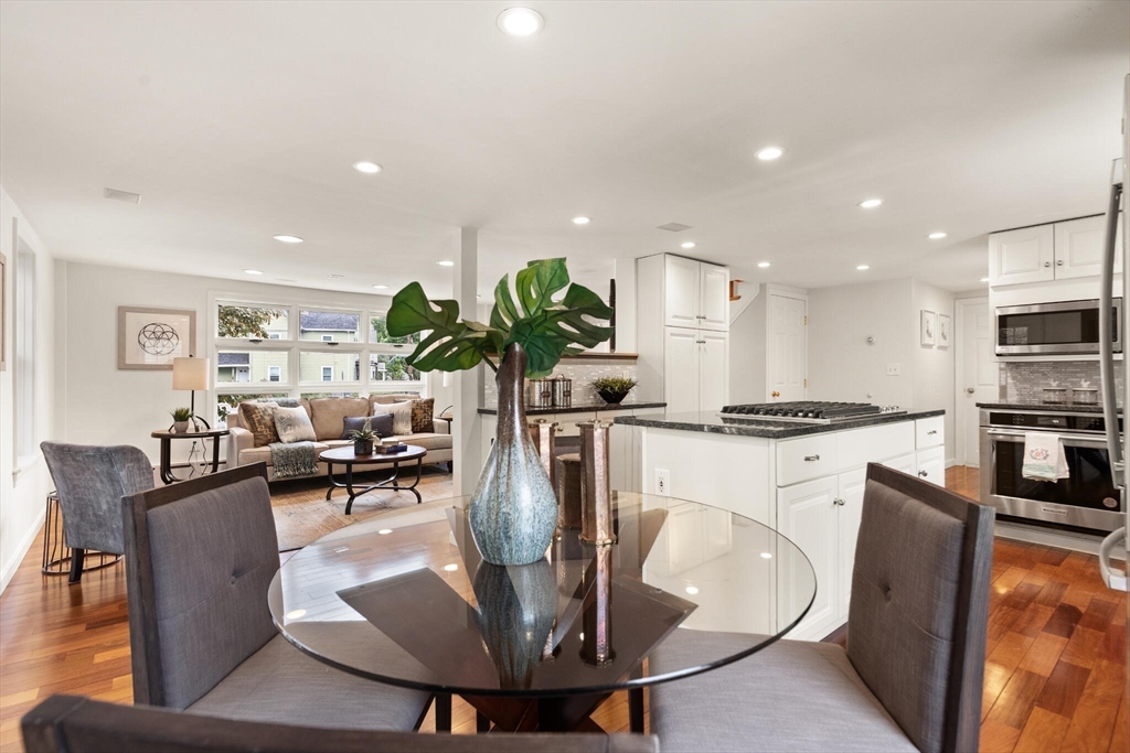 151 Forest Street Malden, MA 02148 - Photo 7 of 33 a dining room with furniture a potted plant and kitchen view