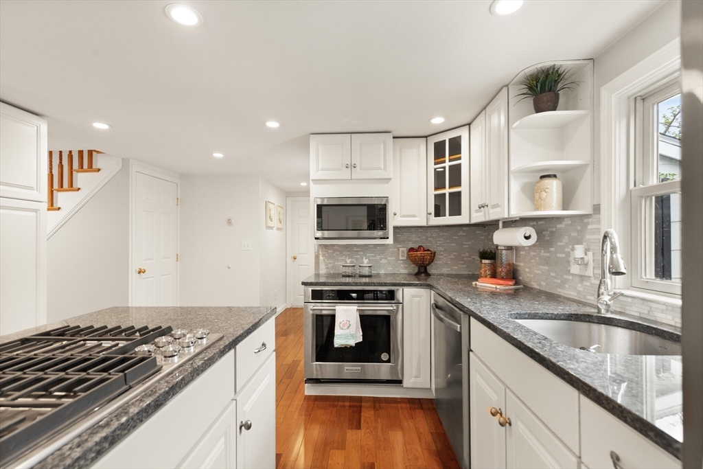 151 Forest Street Malden, MA 02148 - Photo 8 of 33 a kitchen with stainless steel appliances granite countertop a stove and a sink