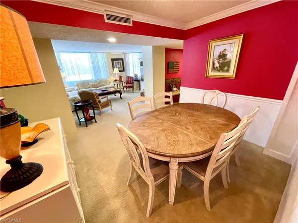 a view of a dining room with furniture and a potted plant