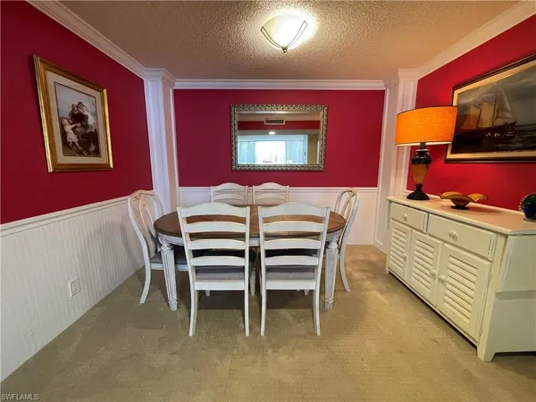 a dining room with furniture and a flat screen tv