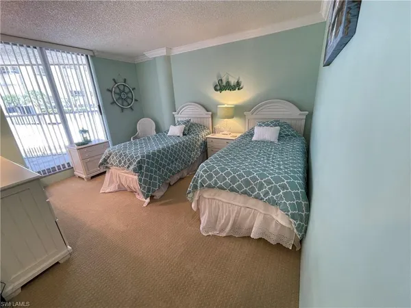 a bedroom with two beds and painted walls