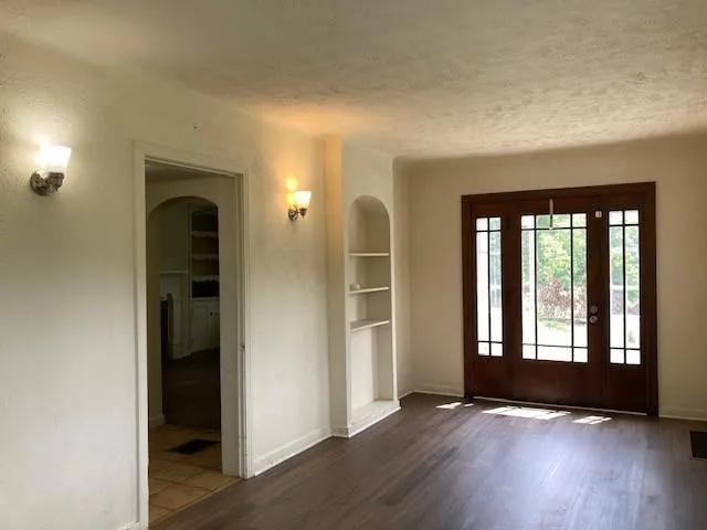 wooden floor in an empty room with a window