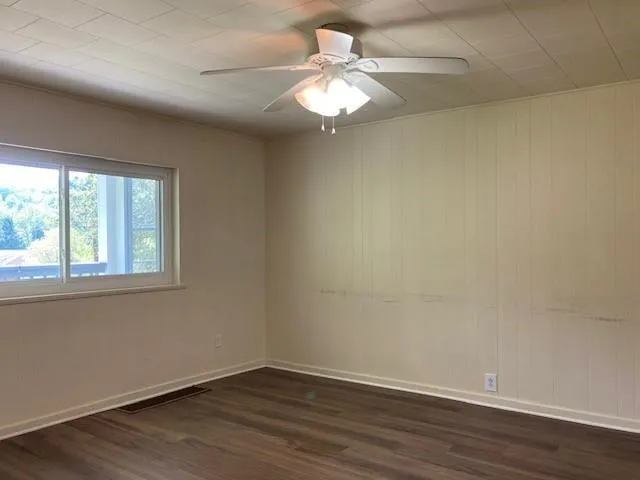 wooden floor in an empty room with a window