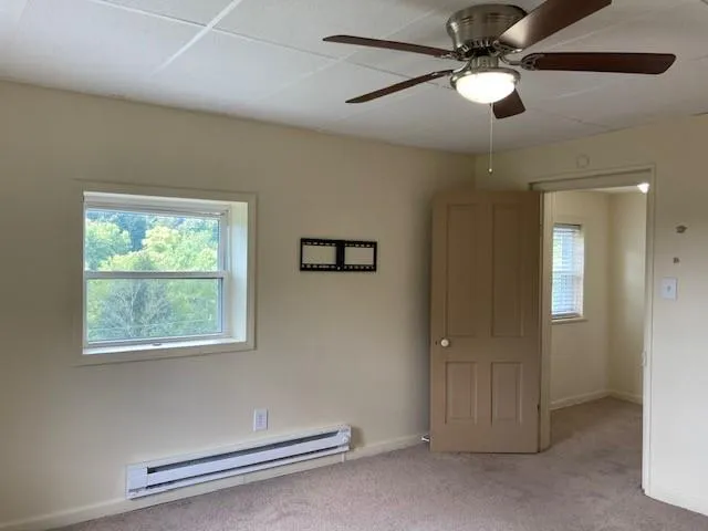 a view of a livingroom with a ceiling fan and a window