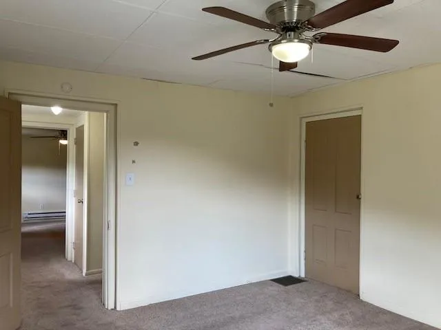 an empty room and chandelier fan