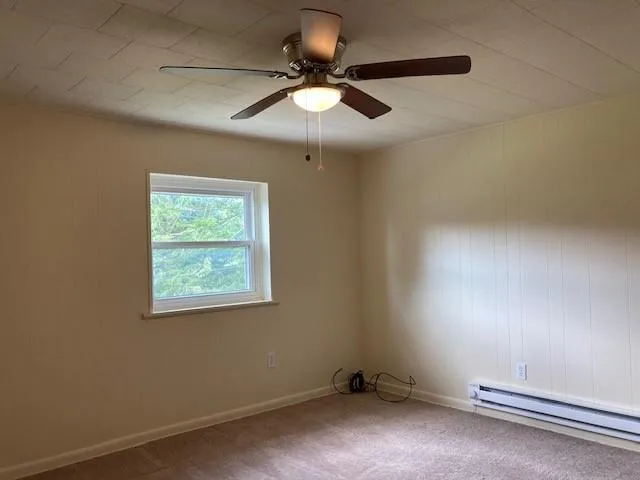 a view of room with a ceiling fan