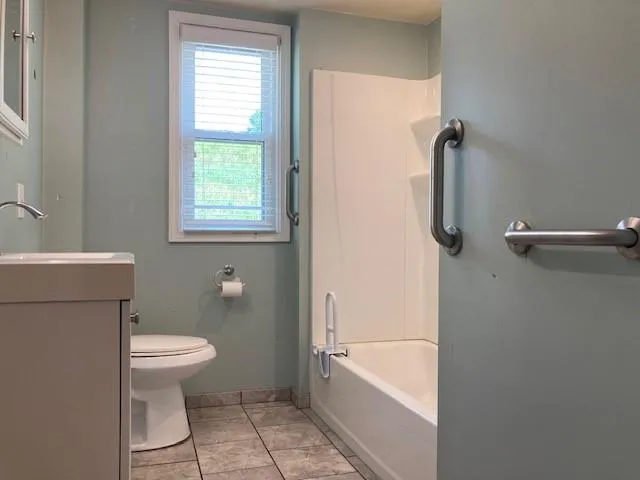 a bathroom with a toilet a sink and bathtub