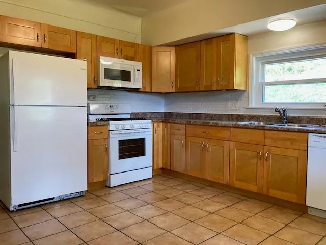 a kitchen with a sink stove and microwave