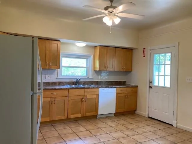 a kitchen with a sink cabinets and window