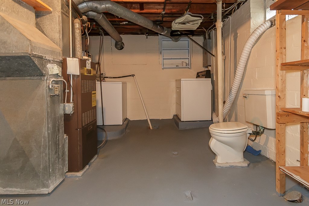 1271 Avondale Road Cleveland, OH 44121 - Photo 31 of 35 Utility area, washer and drier in basement with toilet