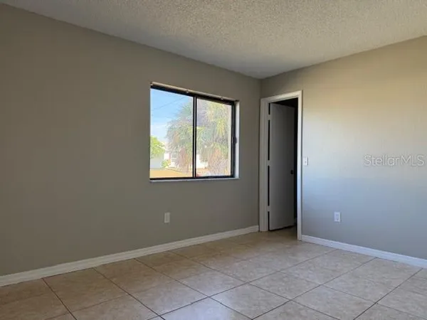 a view of an empty room with a fireplace
