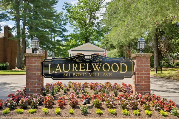 a street sign that is sitting in front of flowers