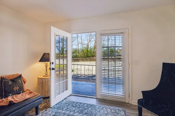 a view of a room with furniture and wooden floor
