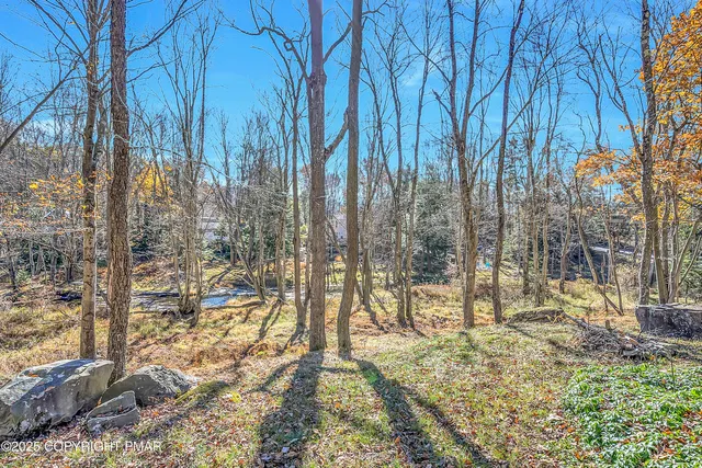 a dining room with furniture a rug and a chandelier