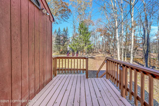 a kitchen with stainless steel appliances granite countertop a table chairs and a refrigerator
