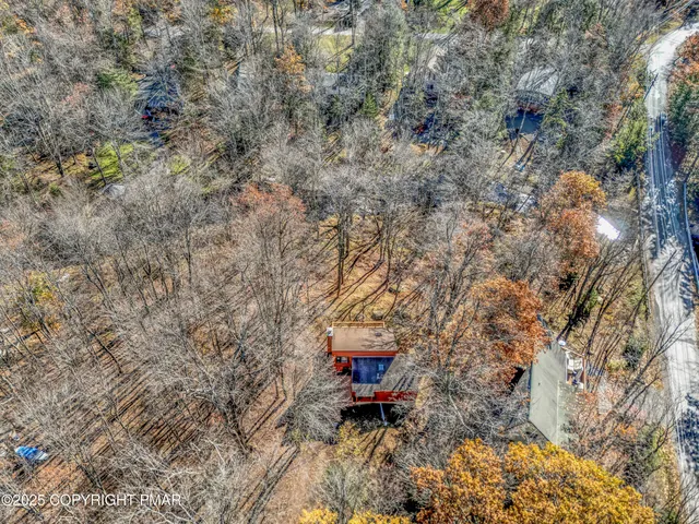 a room with stainless steel appliances kitchen island granite countertop a table chairs and a stove