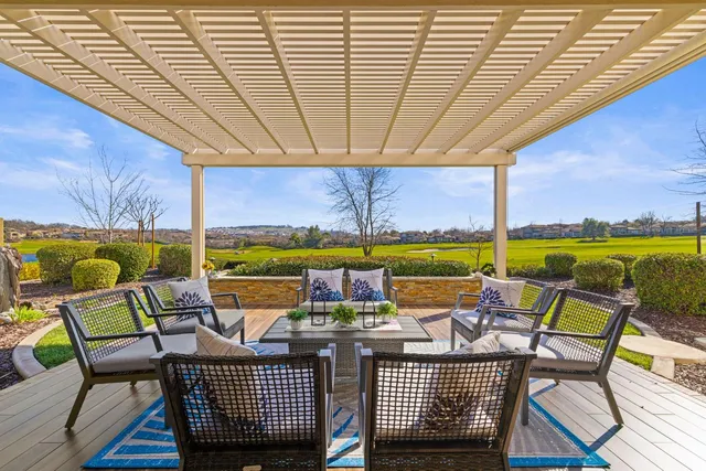 a living room with furniture a fireplace and a large window