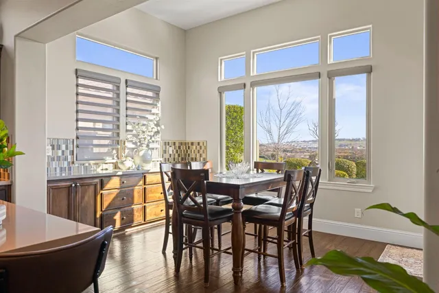 a view of a dining room with furniture window and wooden floor