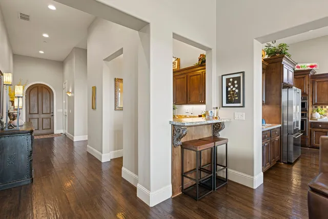 a spacious bathroom with a granite countertop sink a mirror and a shower