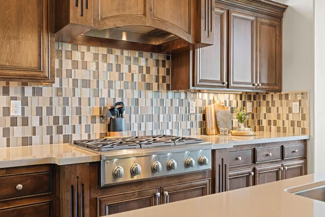 a kitchen with granite countertop a sink cabinets and wooden floor