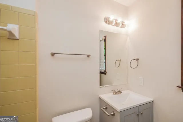 a bathroom with a sink toilet and vanity