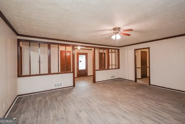 wooden floor in an empty room with a window