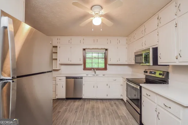 a kitchen with a refrigerator a sink and dishwasher