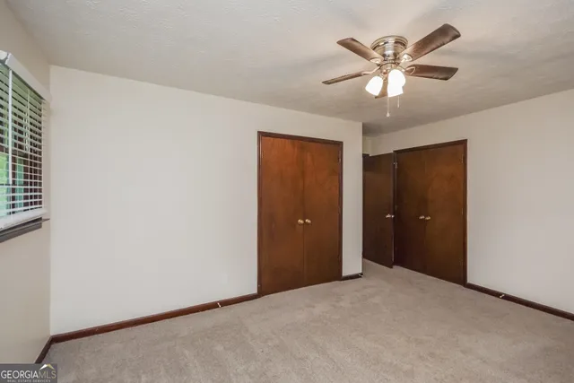 a view of a livingroom with a chandelier fan
