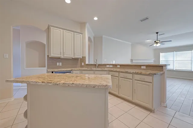 a kitchen with stainless steel appliances granite countertop a sink and a stove