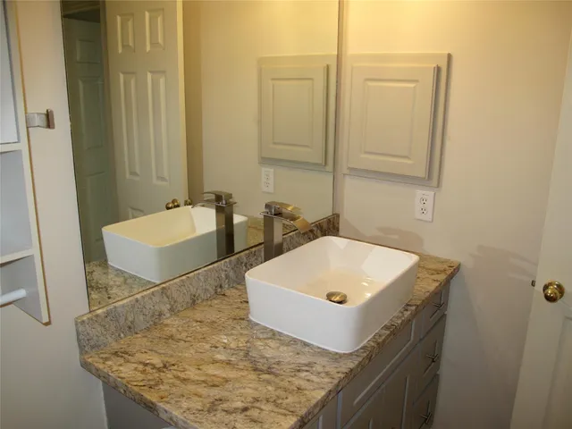 a bathroom with a tub sink and mirror