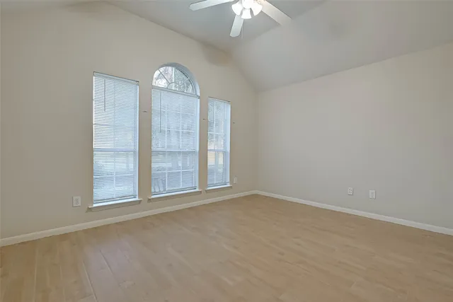 an empty room with a empty space and windows