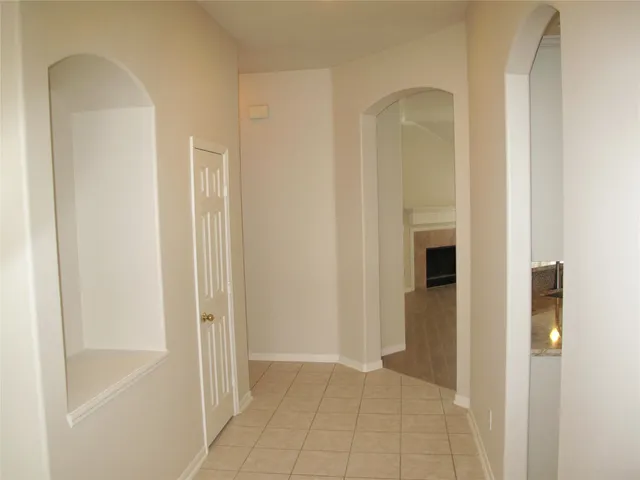 a view of a bathroom with mirror and shower