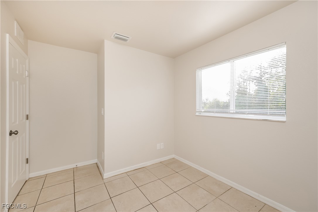 3704 6th Street Southwest Lehigh Acres, FL 33976 - Photo 13 of 16 a view of an empty room with window
