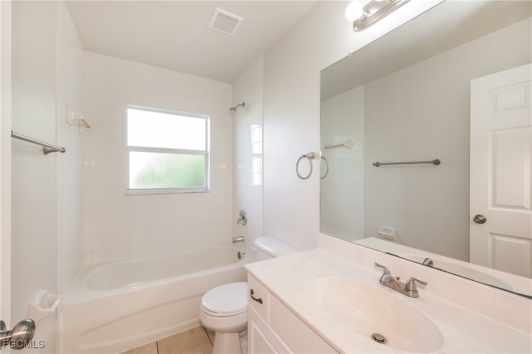 3704 6th Street Southwest Lehigh Acres, FL 33976 - Photo 14 of 16 a bathroom with a sink a toilet and shower