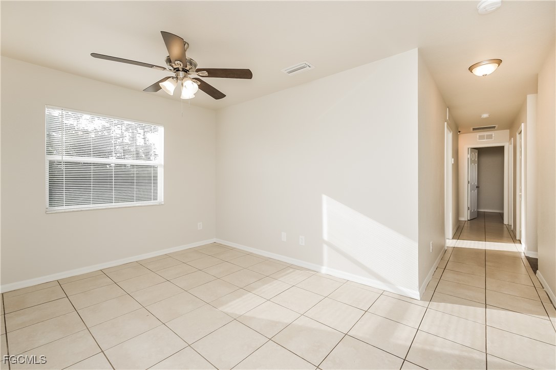 3704 6th Street Southwest Lehigh Acres, FL 33976 - Photo 3 of 16 a view of hallway with windows and chandelier