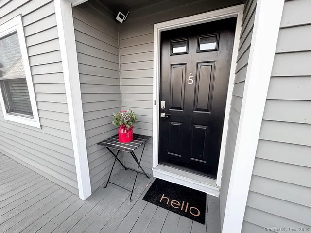 a view of a house with a door and wooden floor