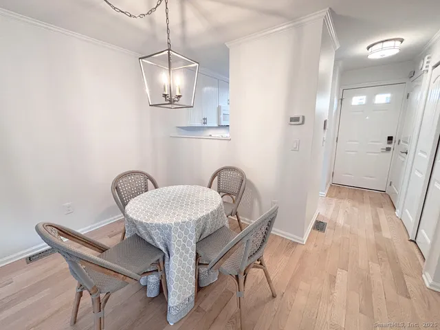 a dining room with furniture and wooden floor