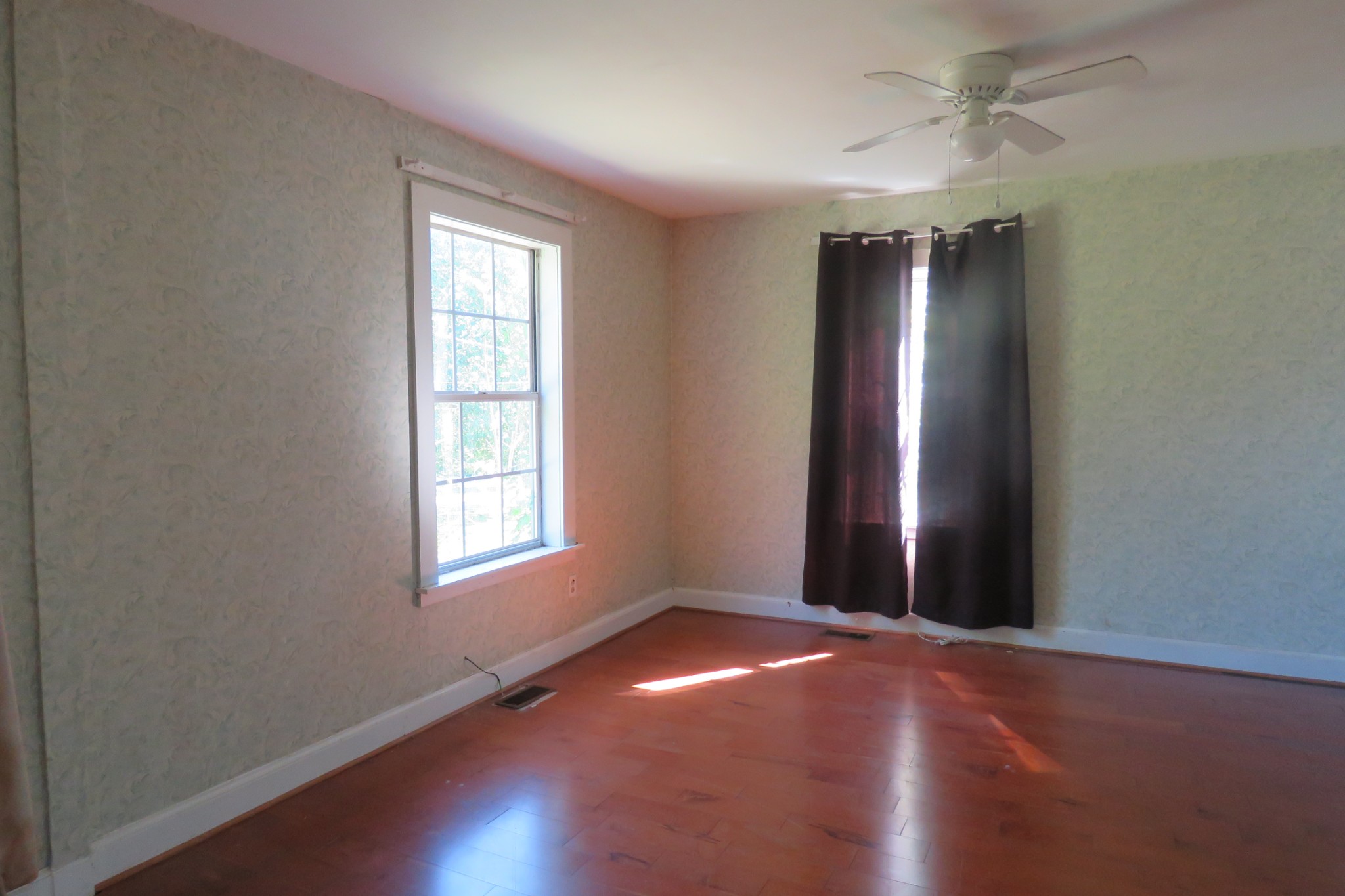 169 Dyer Ridge Road Baxter, TN 38544 - Photo 7 of 25 an empty room with wooden floor and windows in it