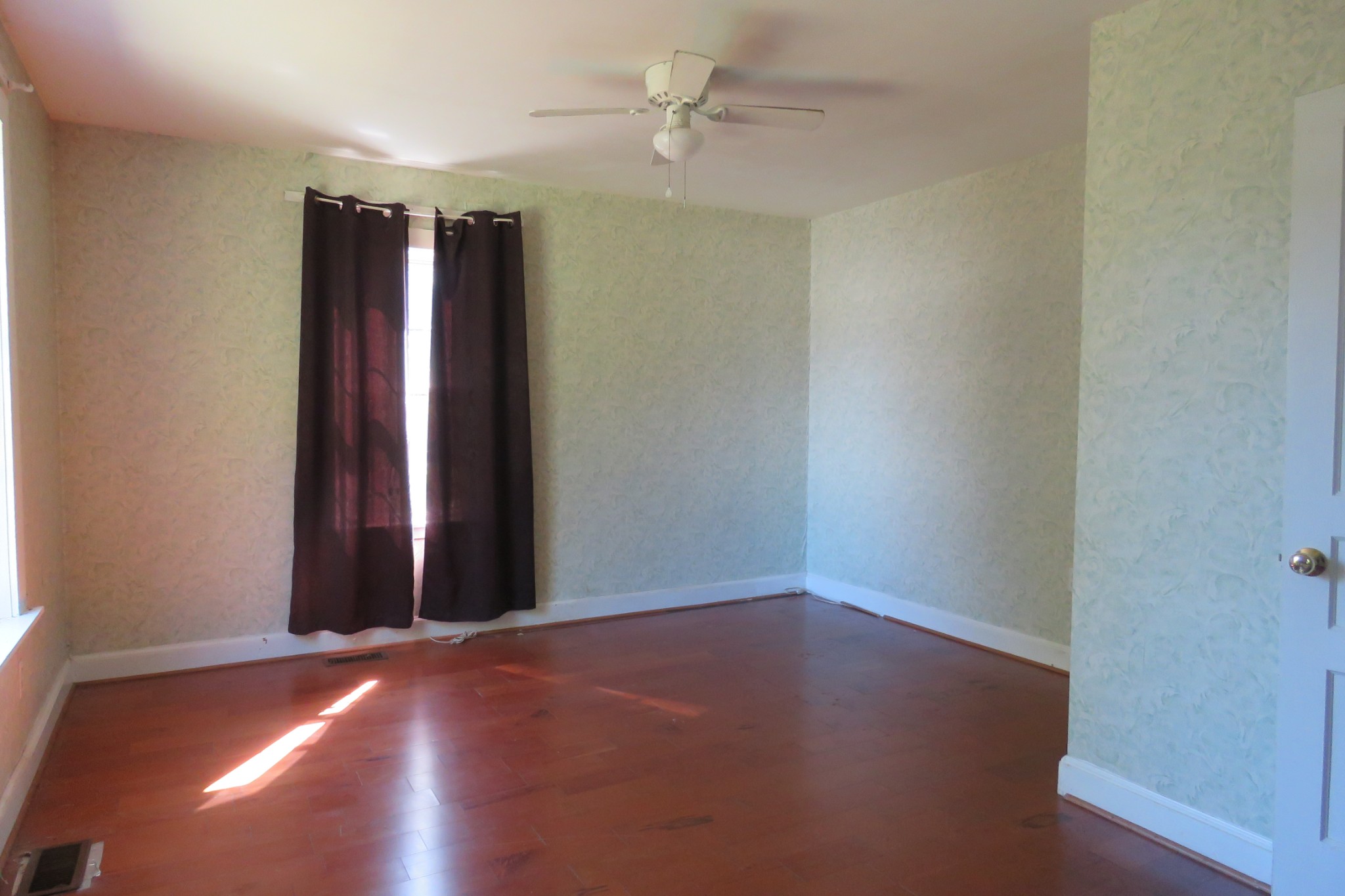 169 Dyer Ridge Road Baxter, TN 38544 - Photo 8 of 25 an empty room with wooden floor and fan