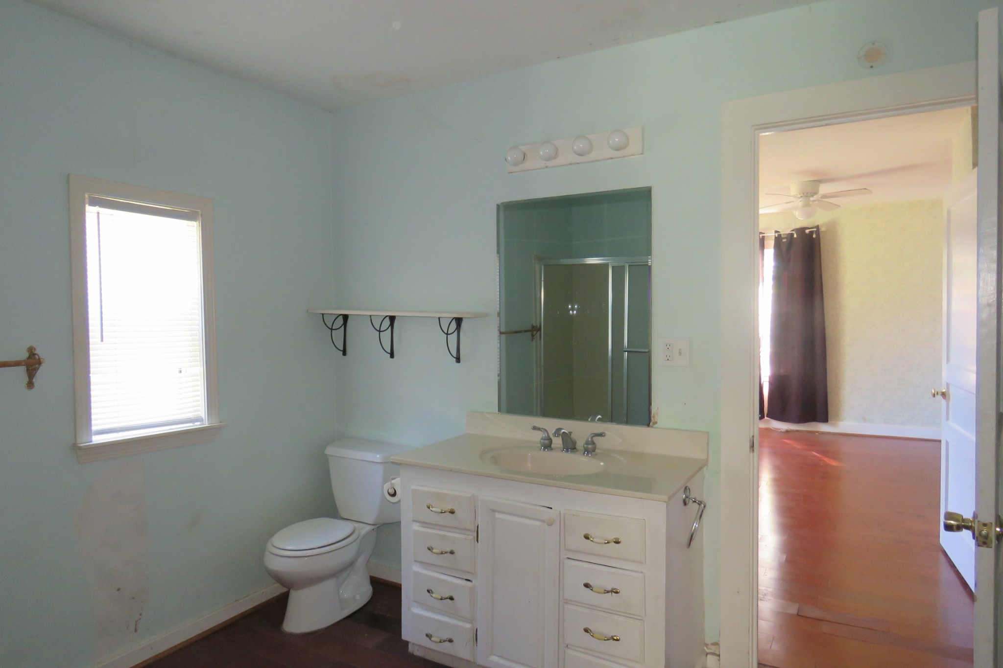 169 Dyer Ridge Road Baxter, TN 38544 - Photo 10 of 25 a bathroom with a granite countertop toilet a sink and a mirror