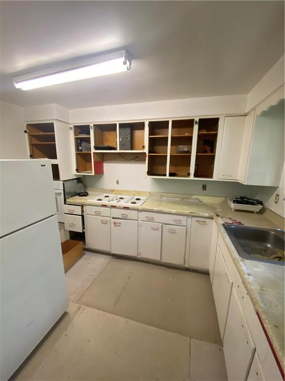 2525 Webster Avenue Pittsburgh, PA 15219 - Photo 7 of 11 a kitchen with a stove sink and cabinets